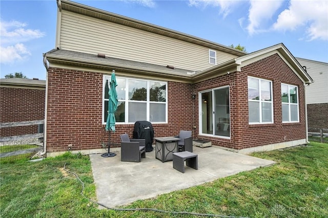 4546 Brackenview Ct, Mason, OH 45040 - rear view of house featuring brick siding, a lawn, and a patio area