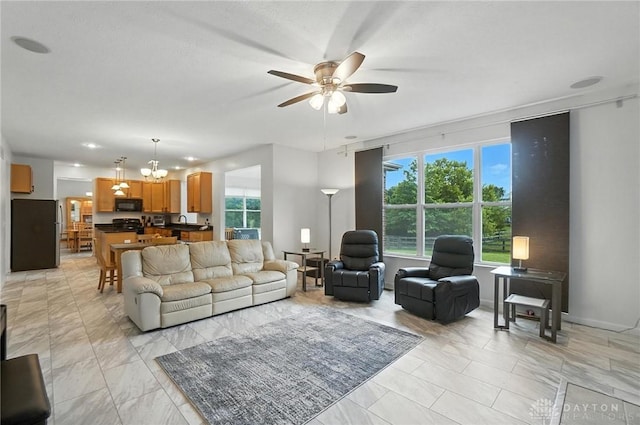4546 Brackenview Ct, Mason, OH 45040 - living room with ceiling fan, a chandelier, and light marble finish flooring