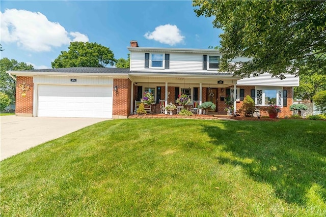 429 Rader Dr, Vandalia, OH 45377 - view of front of house with an attached garage, brick siding, and a chimney