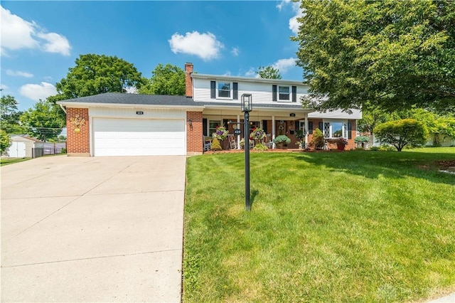 429 Rader Dr, Vandalia, OH 45377 - traditional-style house with a garage, a chimney, concrete driveway, a front yard, and brick siding