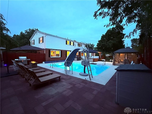 429 Rader Dr, Vandalia, OH 45377 - view of pool with a gazebo, a patio area, a water slide, and an outdoor kitchen