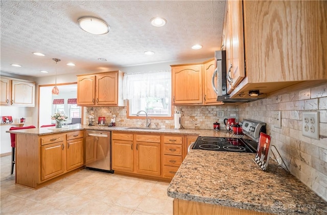 429 Rader Dr, Vandalia, OH 45377 - kitchen with stainless steel appliances, a peninsula, a textured ceiling, light stone countertops, and a kitchen bar