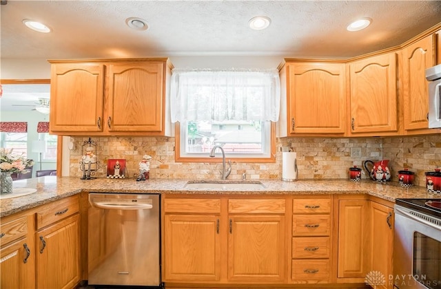 429 Rader Dr, Vandalia, OH 45377 - kitchen featuring stainless steel appliances, light stone counters, ceiling fan, decorative backsplash, and recessed lighting