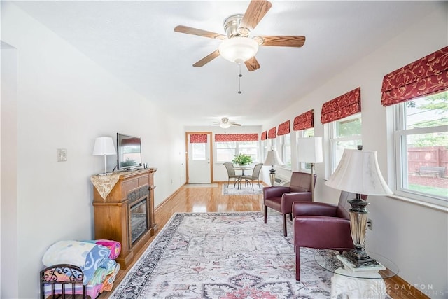429 Rader Dr, Vandalia, OH 45377 - living room featuring plenty of natural light, wood finished floors, ceiling fan, and a glass covered fireplace
