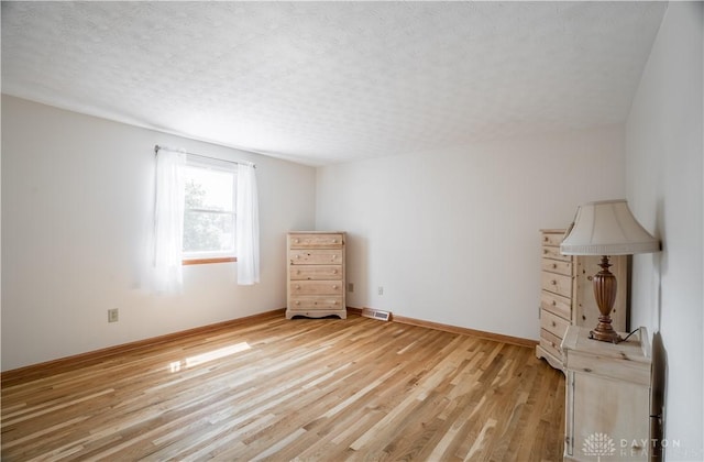 429 Rader Dr, Vandalia, OH 45377 - unfurnished bedroom featuring light wood-style floors and a textured ceiling