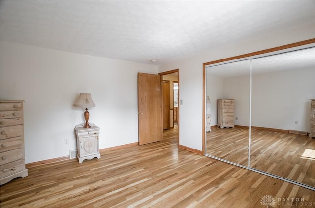 429 Rader Dr, Vandalia, OH 45377 - unfurnished bedroom featuring light wood-style floors and a closet