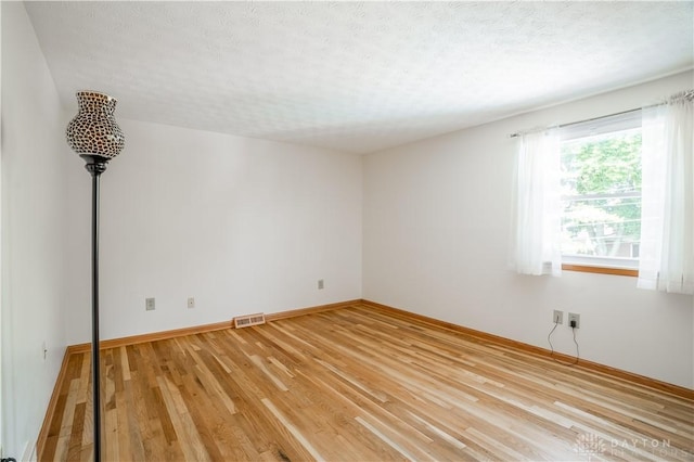 429 Rader Dr, Vandalia, OH 45377 - spare room with light wood-style flooring and a textured ceiling