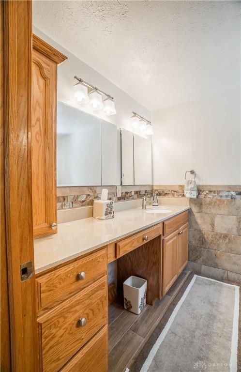 429 Rader Dr, Vandalia, OH 45377 - bathroom featuring vanity, a textured ceiling, and wood finished floors