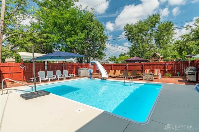 429 Rader Dr, Vandalia, OH 45377 - view of pool featuring a water slide, a patio, grilling area, and a fenced backyard