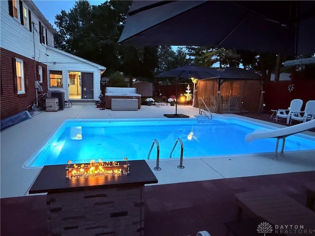 429 Rader Dr, Vandalia, OH 45377 - view of swimming pool with a water slide, a patio area, an outdoor fire pit, and a jacuzzi