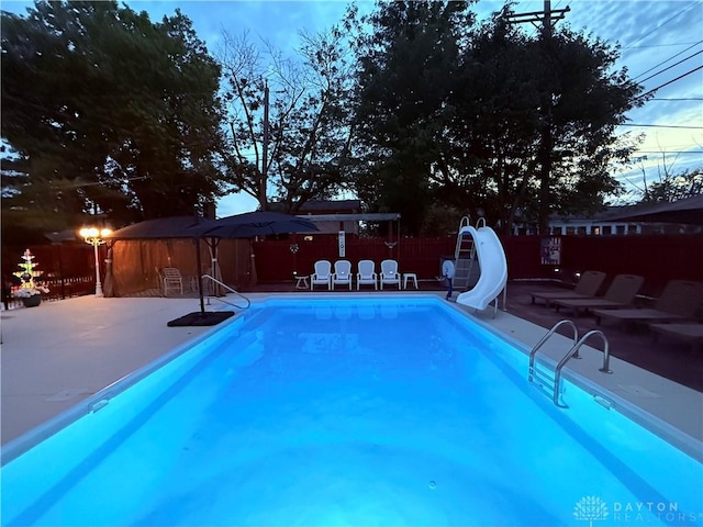 429 Rader Dr, Vandalia, OH 45377 - view of pool with a patio area, a water slide, and a fenced backyard