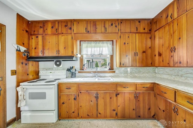 677 Ridgewood Ave, Hamilton, OH 45013 - kitchen featuring white range with electric stovetop, brown cabinets, light countertops, and tasteful backsplash