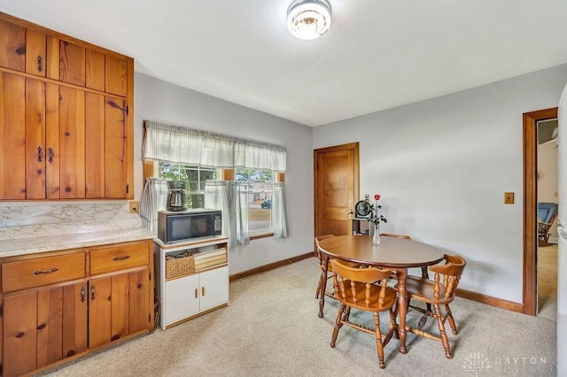 677 Ridgewood Ave, Hamilton, OH 45013 - dining area with baseboards and light colored carpet