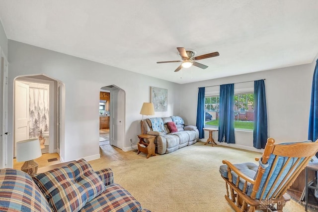 677 Ridgewood Ave, Hamilton, OH 45013 - living room with arched walkways, a ceiling fan, and light colored carpet