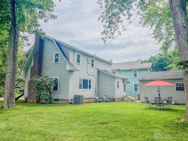1110 E Main St, Troy, OH 45373 - back of house with a yard and a chimney