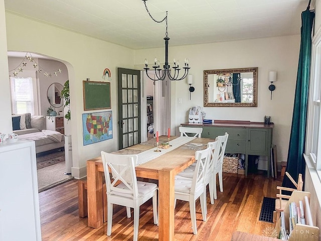 1110 E Main St, Troy, OH 45373 - dining room with a chandelier, light wood-style floors, arched walkways, and french doors
