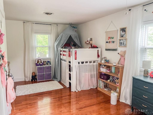 1110 E Main St, Troy, OH 45373 - bedroom with multiple windows and wood finished floors