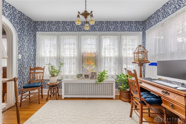 288 N King St, Xenia, OH 45385 - office space featuring radiator, wallpapered walls, arched walkways, wood finished floors, and a chandelier