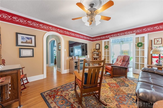 288 N King St, Xenia, OH 45385 - living room featuring ornamental molding, arched walkways, wood finished floors, and a ceiling fan
