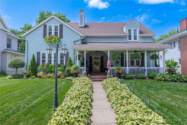 288 N King St, Xenia, OH 45385 - view of front of property featuring covered porch, a front lawn, stucco siding, a chimney, and a ceiling fan