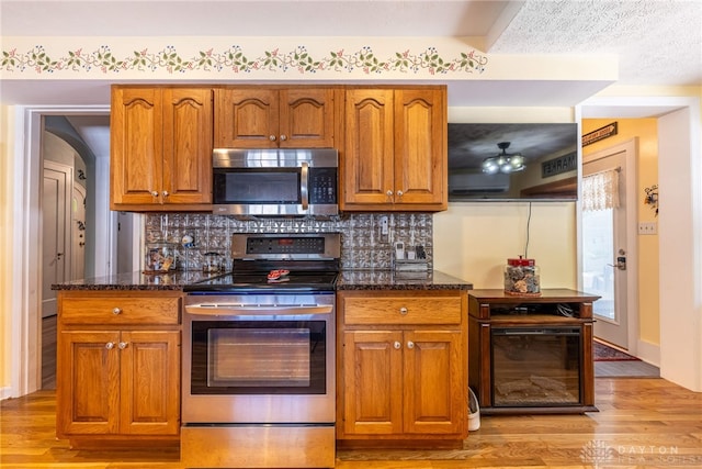 288 N King St, Xenia, OH 45385 - kitchen featuring stainless steel appliances, light wood-style floors, and dark stone counters