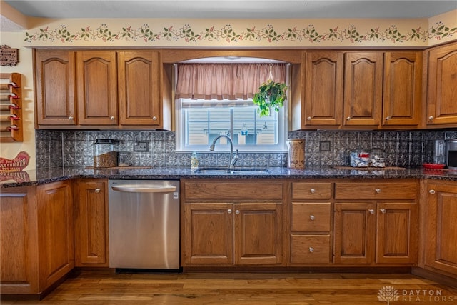 288 N King St, Xenia, OH 45385 - kitchen with stainless steel dishwasher, brown cabinets, dark stone counters, and wood finished floors