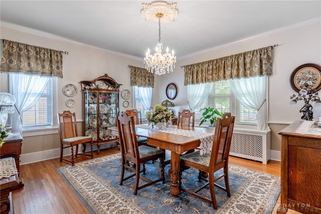 288 N King St, Xenia, OH 45385 - dining area featuring a chandelier, ornamental molding, wood finished floors, and radiator heating unit