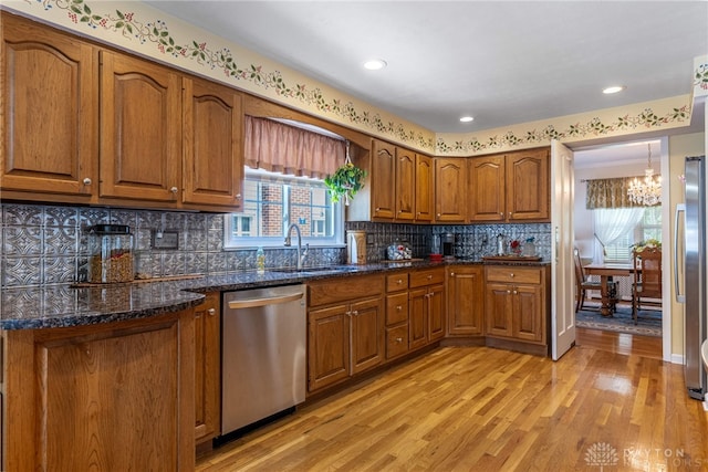 288 N King St, Xenia, OH 45385 - kitchen with stainless steel appliances, a chandelier, brown cabinets, light wood finished floors, and recessed lighting