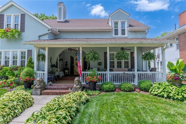 288 N King St, Xenia, OH 45385 - back of house with a porch, ceiling fan, stucco siding, and a yard