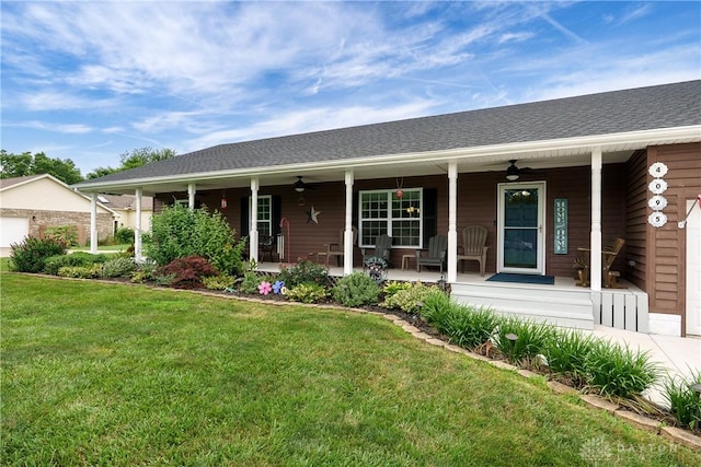 4095 N State Route 42, Waynesville, OH 45068 - ranch-style house featuring a porch, a ceiling fan, a front lawn, and a garage