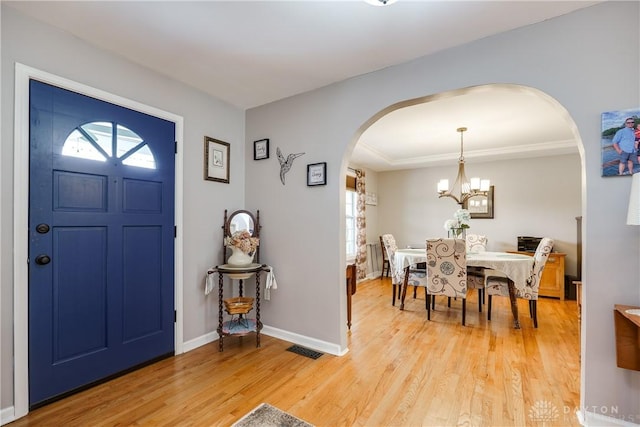 4095 N State Route 42, Waynesville, OH 45068 - foyer featuring arched walkways, light wood-style floors, and a chandelier