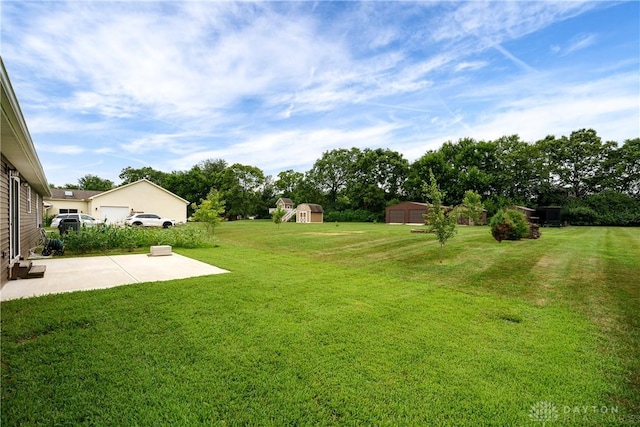 4095 N State Route 42, Waynesville, OH 45068 - view of green lawn with a patio and a storage unit