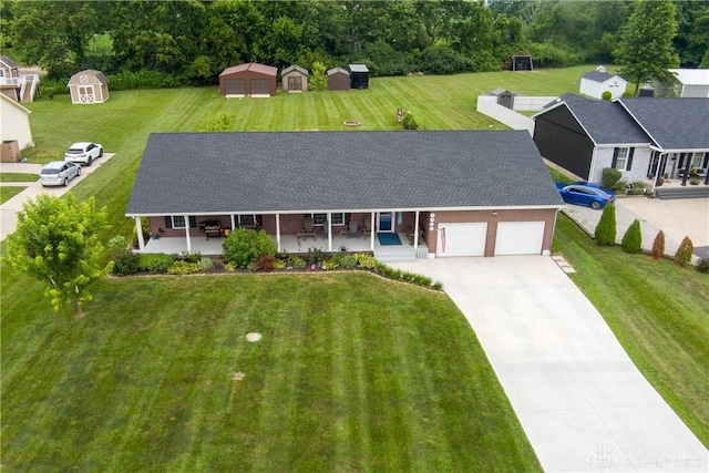 4095 N State Route 42, Waynesville, OH 45068 - view of front of home with a storage shed, a garage, covered porch, concrete driveway, and a front yard