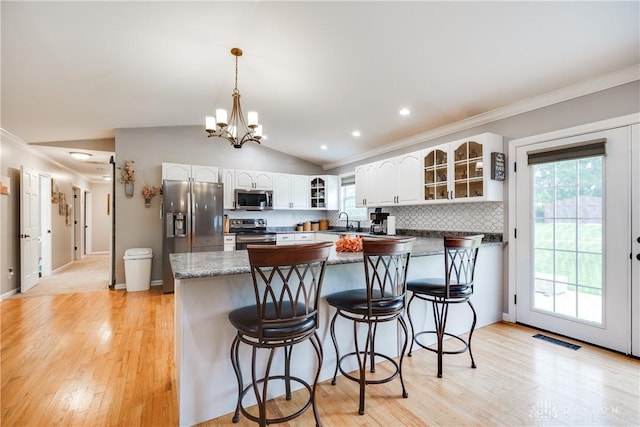 4095 N State Route 42, Waynesville, OH 45068 - kitchen with stainless steel appliances, a peninsula, glass insert cabinets, ornamental molding, and white cabinetry