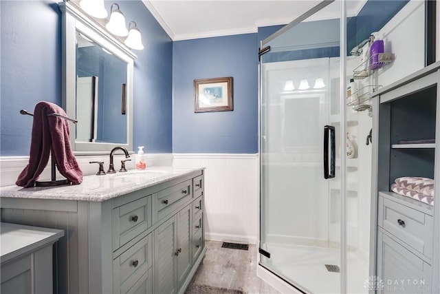 4095 N State Route 42, Waynesville, OH 45068 - bathroom featuring a shower stall, vanity, a wainscoted wall, wood finished floors, and crown molding