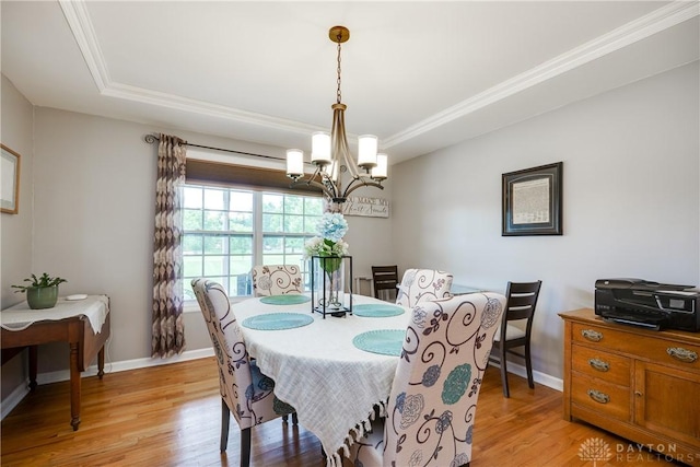 4095 N State Route 42, Waynesville, OH 45068 - dining room featuring a tray ceiling, a chandelier, light wood-type flooring, and ornamental molding