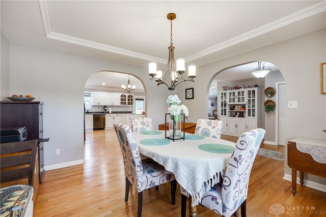 4095 N State Route 42, Waynesville, OH 45068 - dining area featuring arched walkways, a tray ceiling, a chandelier, and ornamental molding