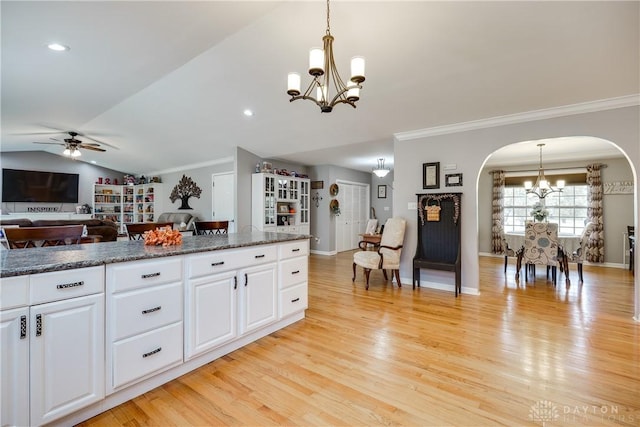 4095 N State Route 42, Waynesville, OH 45068 - kitchen featuring a chandelier, arched walkways, ornamental molding, ceiling fan, and light wood-style flooring