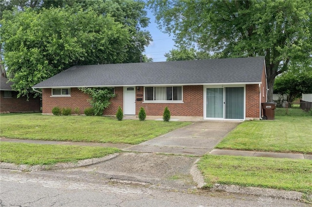 2227 Los Arrow Dr, Dayton, OH 45439 - ranch-style house featuring a front yard, brick siding, and a shingled roof