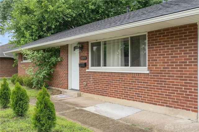 2227 Los Arrow Dr, Dayton, OH 45439 - view of exterior entry with brick siding and roof with shingles