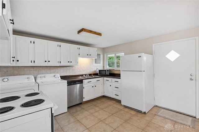 2227 Los Arrow Dr, Dayton, OH 45439 - kitchen with stainless steel appliances, separate washer and dryer, white cabinetry, and decorative backsplash