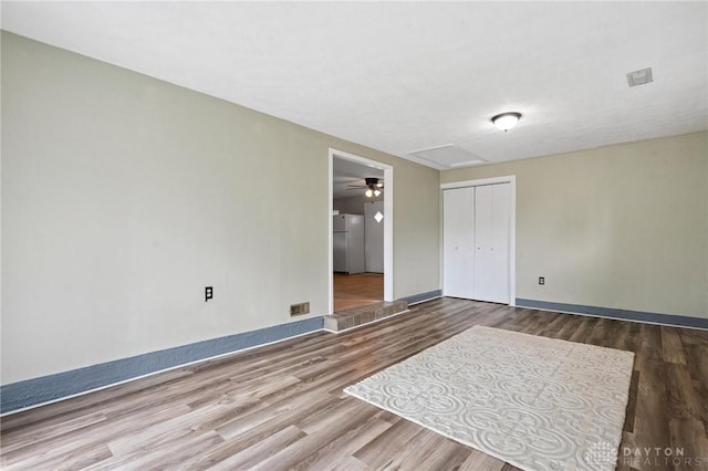 2227 Los Arrow Dr, Dayton, OH 45439 - unfurnished bedroom with freestanding refrigerator, wood finished floors, a closet, and attic access