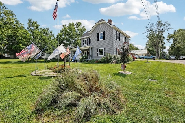 213 N Broadway St, Blanchester, OH 45107 - rear view of property with a chimney and a yard