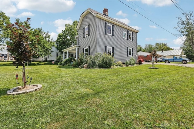 213 N Broadway St, Blanchester, OH 45107 - view of home's exterior featuring a chimney and a lawn