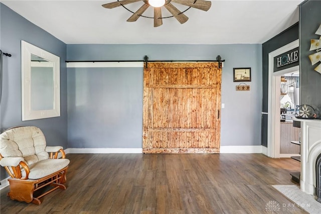 213 N Broadway St, Blanchester, OH 45107 - sitting room featuring ceiling fan, wood finished floors, and a barn door