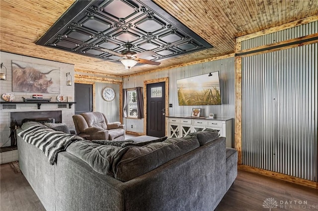 213 N Broadway St, Blanchester, OH 45107 - living room with wood finished floors, wooden walls, a fireplace, ceiling fan, and an ornate ceiling
