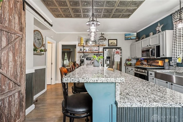 213 N Broadway St, Blanchester, OH 45107 - kitchen featuring appliances with stainless steel finishes, dark wood-type flooring, light stone countertops, a center island, and an ornate ceiling