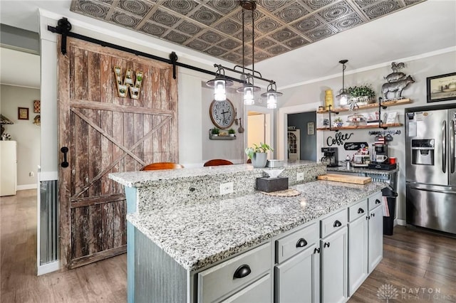 213 N Broadway St, Blanchester, OH 45107 - kitchen with stainless steel fridge with ice dispenser, a barn door, dark wood-type flooring, an ornate ceiling, and light stone counters