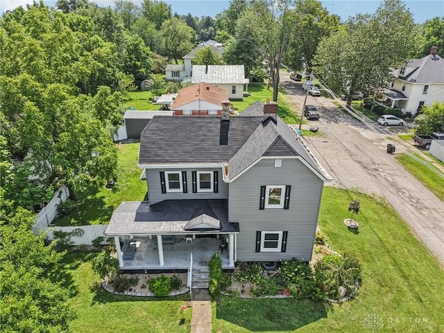 213 N Broadway St, Blanchester, OH 45107 - rear view of house featuring a lawn, roof with shingles, and covered porch