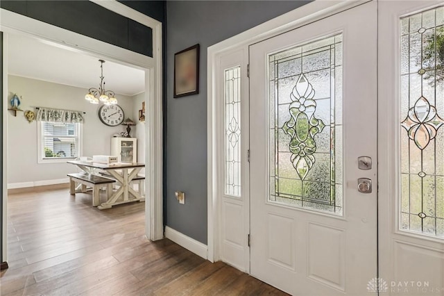213 N Broadway St, Blanchester, OH 45107 - foyer entrance with a chandelier and dark wood-style flooring